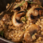 image of mushroom risotto against a dark moody background