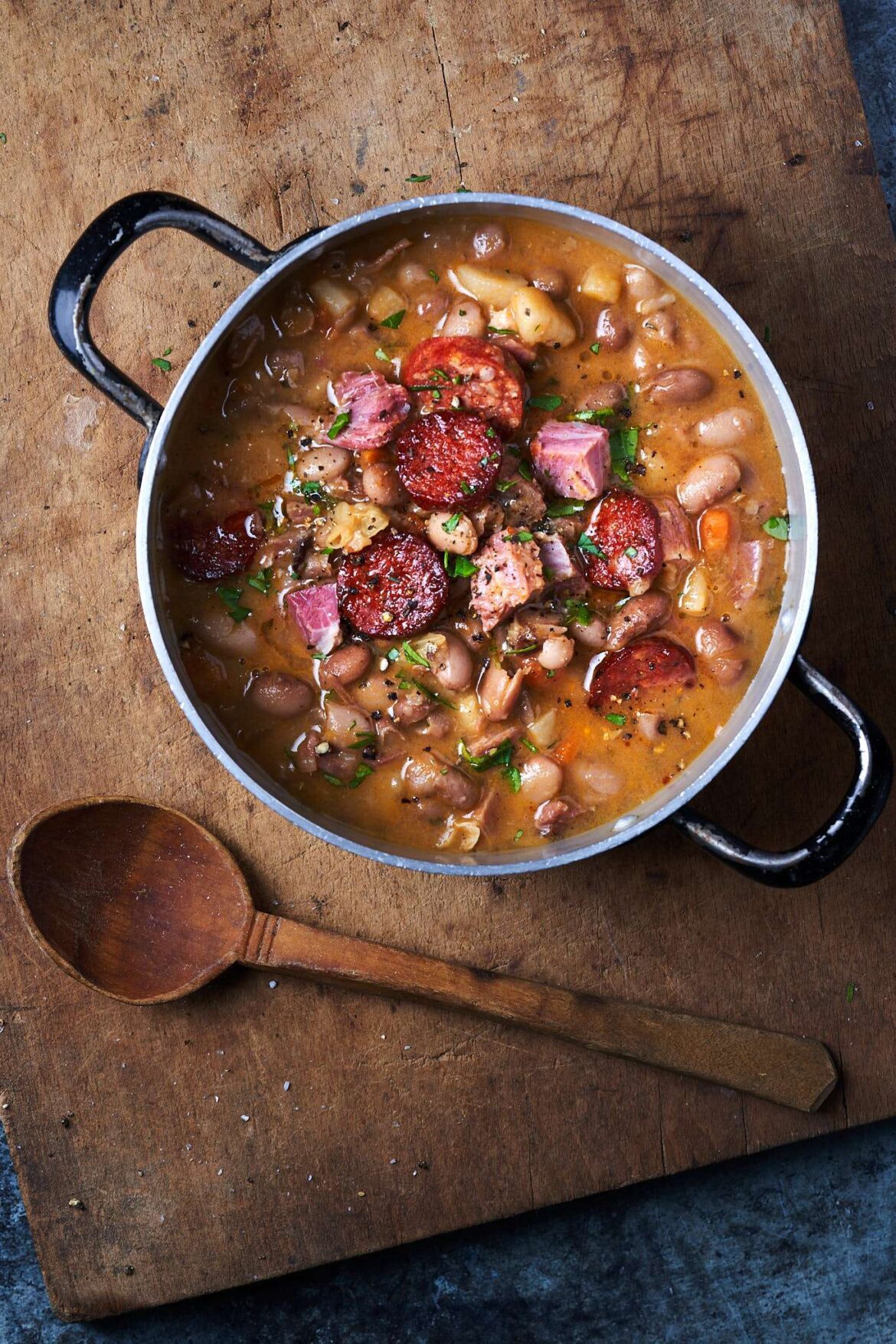 Photo of Hungarian Jókai bableves bean soup in a rustic setting