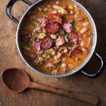 Photo of Hungarian Jókai bableves bean soup in a rustic setting
