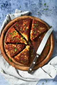 photo of frico from Friuli made from Montasio cheese and potatoes in a rustic setting