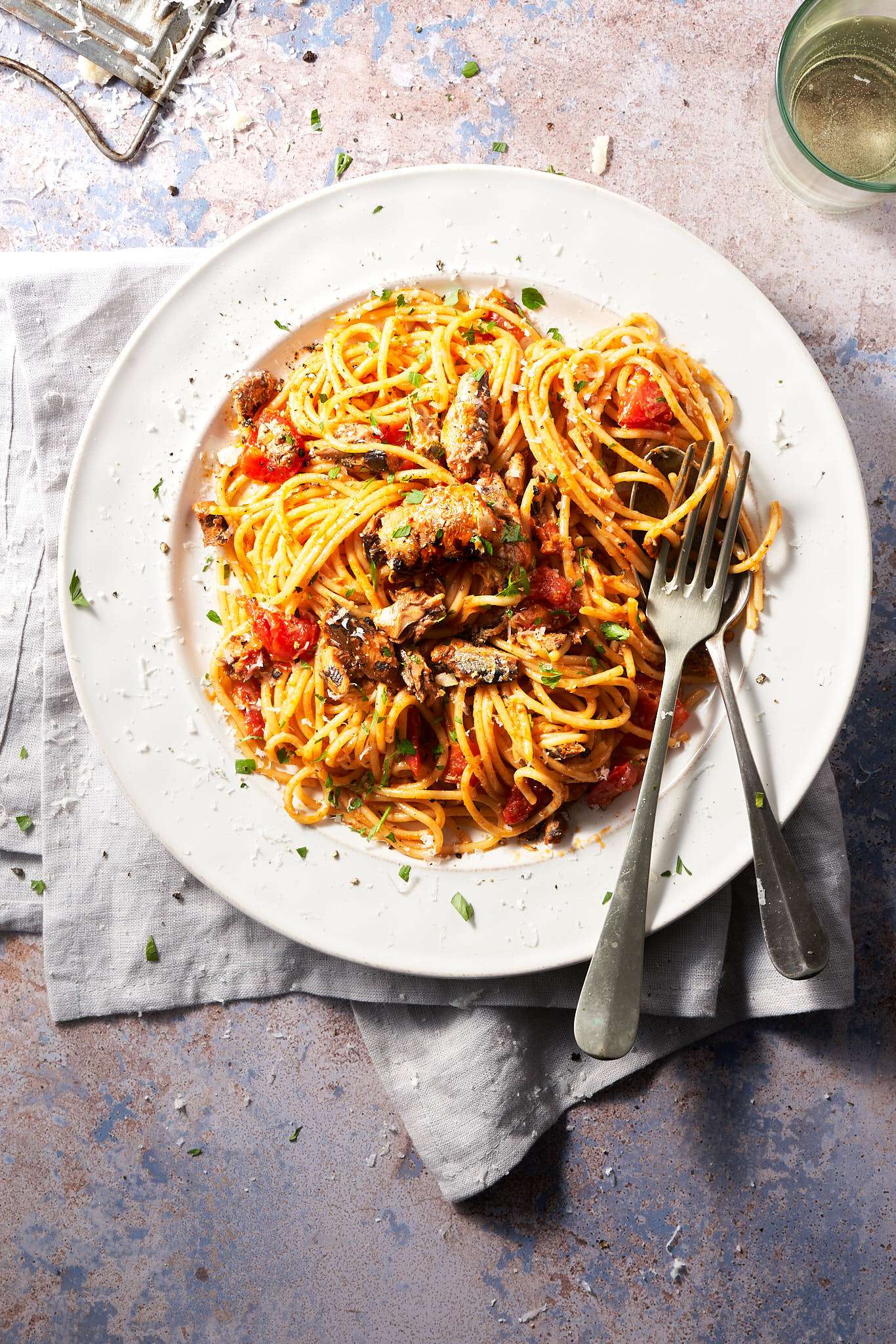 image of Spaghetti con sardine con pomodoro in a rustic setting from the Adriatic coast of Friuli in Italy's north