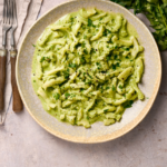 image of trippa all' anconetana, a tripe dish from Ancona in the Marche region of Italy, served in a wide bowl and garnished with freshly chopped parsley.