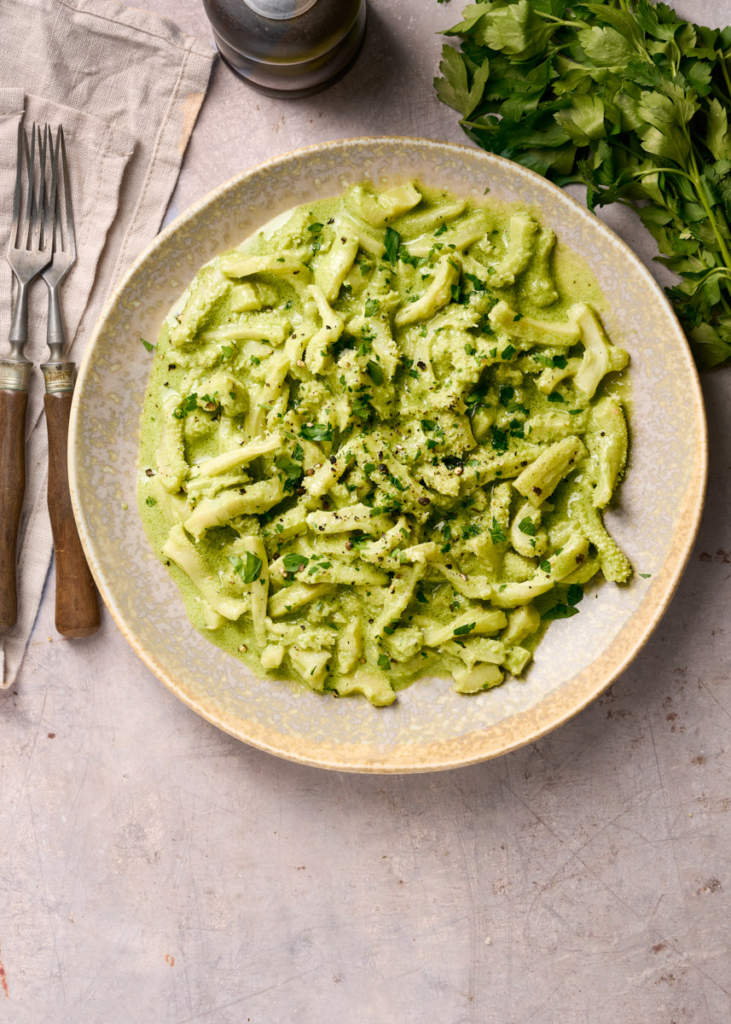 image of trippa all' anconetana, a tripe dish from Ancona in the Marche region of Italy, served in a wide bowl and garnished with freshly chopped parsley.