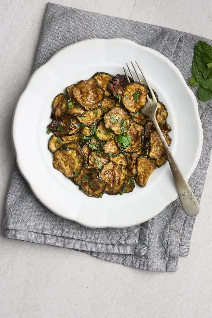 rustic image of zucchini a scapece, fried zucchini in a vinegar and mint marinade