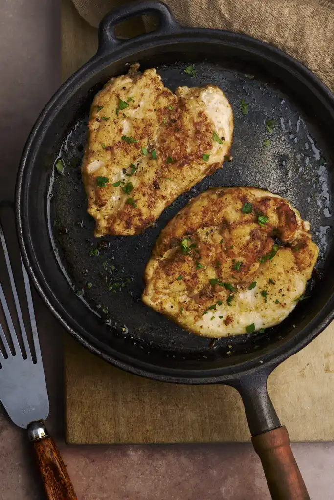 rustic image of petit di pollo alla fiorentina, a delicious floured chicken breast pan fried in butter