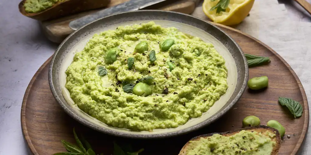 rustic image of pesto di fave or fava bean pesto with bruschetta