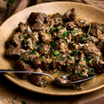 Image of cacio e ova, a traditional Abruzzo Easter lamb stew served in a wide plate on a wooden board, garnished with rosemary