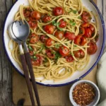 image of Bucatini alla Rafilina, a pasta dish with cherry tomatoes and parsley with a pinch of chilli from the Campania region.