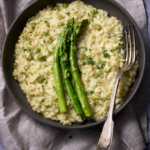 image of asparagus risotto on a dark plate and napkin