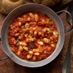 image of tuscan baked beans (Fagioli all'Uccelletto) in a rustic setting