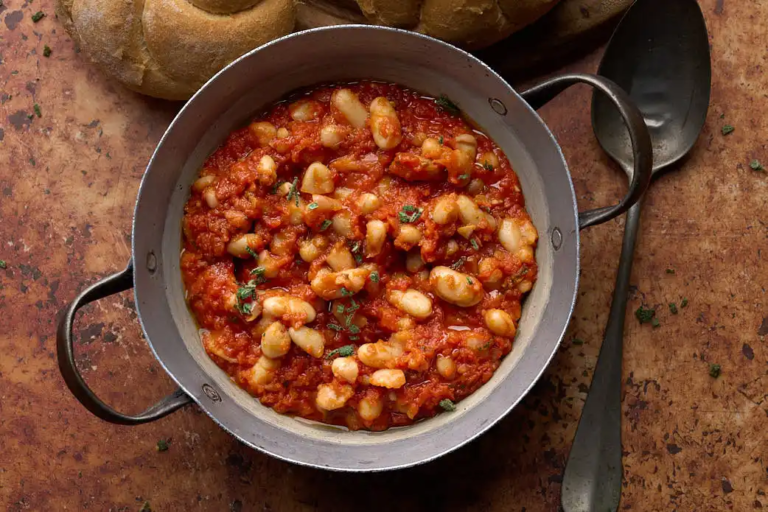 image of tuscan baked beans (Fagioli all'Uccelletto) in a rustic setting