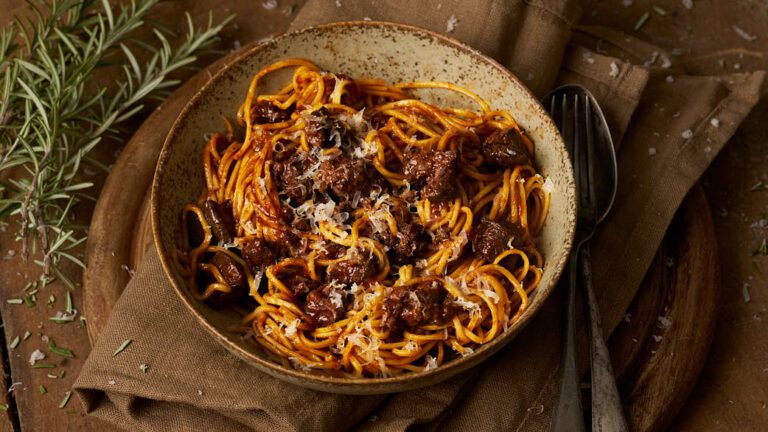 Rustic image of tajarin con feasting di pollo, a traditional pasta dish from Piedmont using the regional tajarin egg pasta.