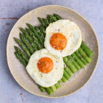 image of asparagus with fried egg (asparagi alla milanese) which is one of the best dishes to eat in the Italian Spring.