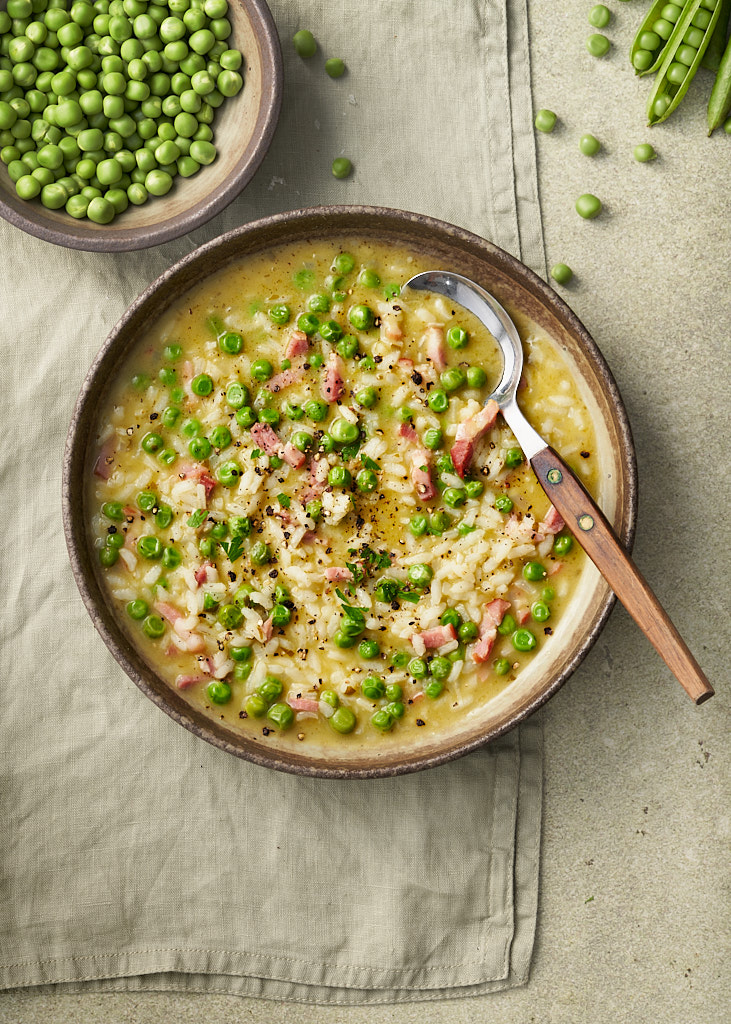 image of delicious bowl of Risi e Bisi which is a spring italian dish of rice and peas that is somewhere between a soup and a risotto