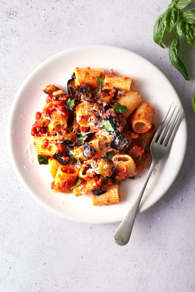 image of tasty sicilian pasta alla norma pasta with aubergines on a white plate