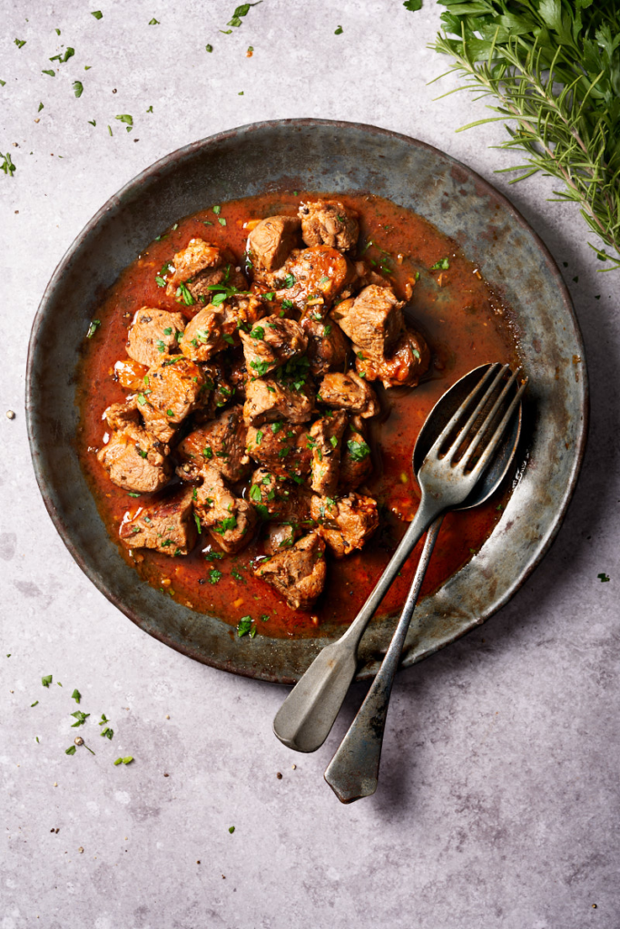 image of Potacchio Marcchegiano, a rustic dish from Italy's Marche region, served in a wide rustic bowl.