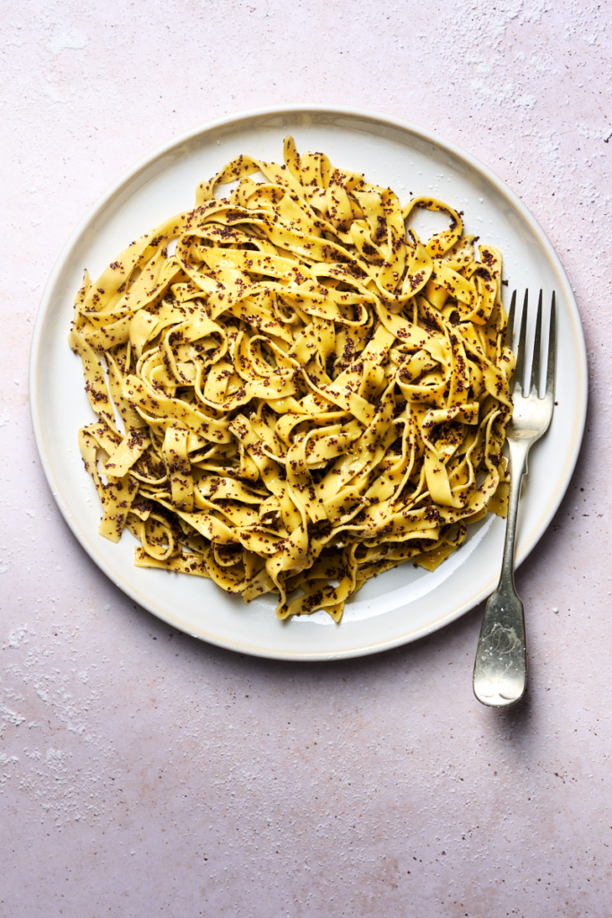 image of Lasagne ai semi di papavero served on a white plate and dressed with poppy seeds