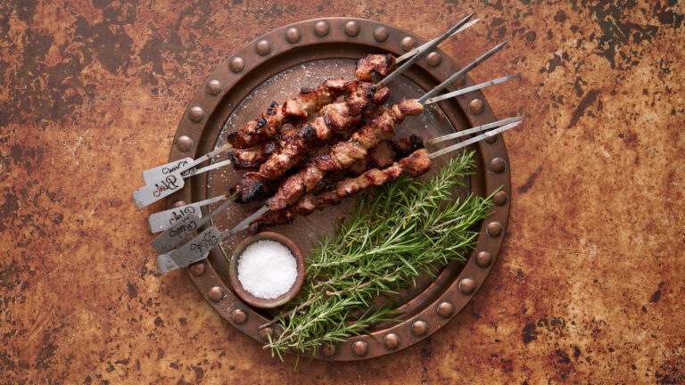 image of Arrosticini on metal skewers with rosemary