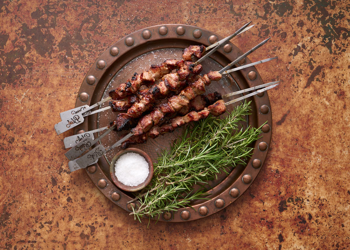 image of Arrosticini on metal skewers with rosemary