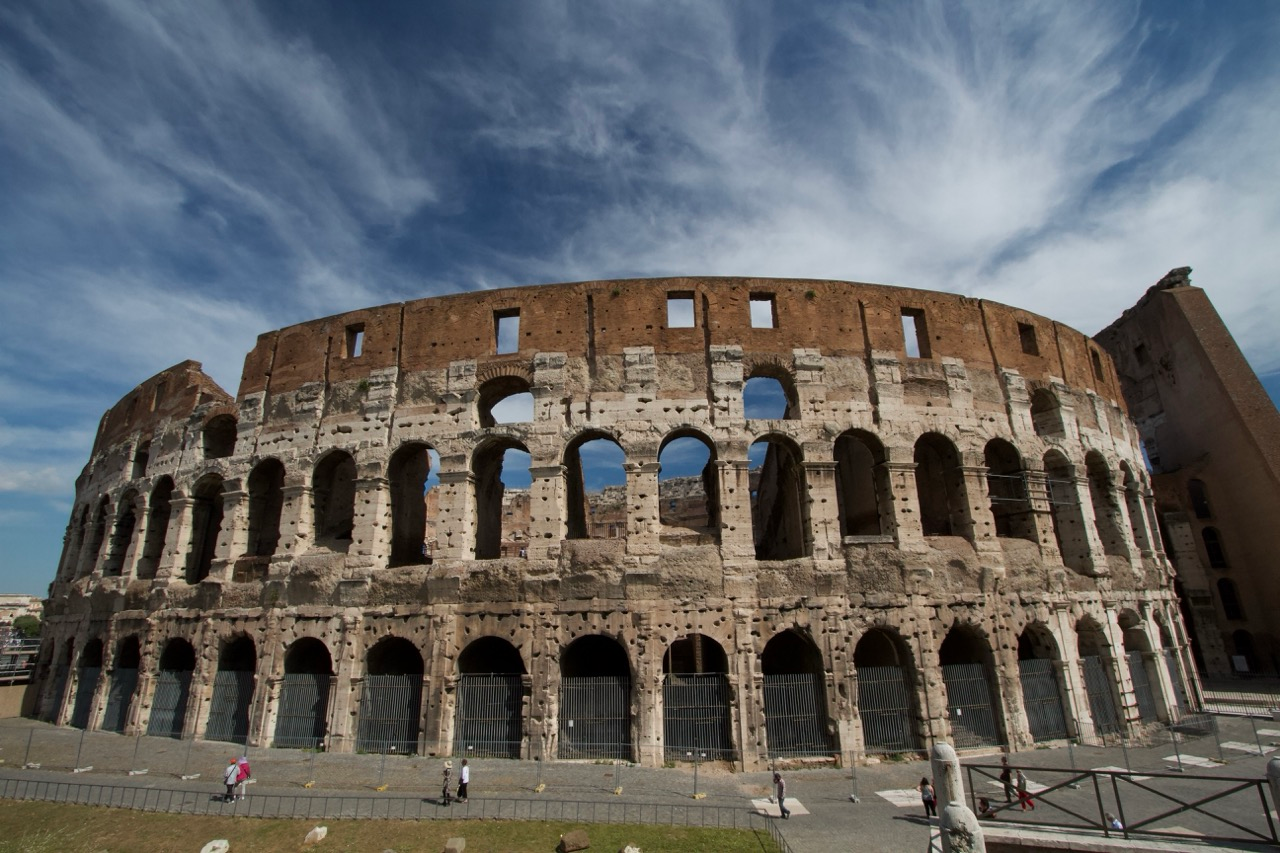 Image of Rome's colosseum with blue sky and wispy clouds
